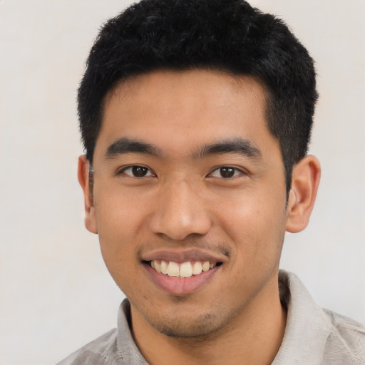 Joyful asian young-adult male with short  black hair and brown eyes