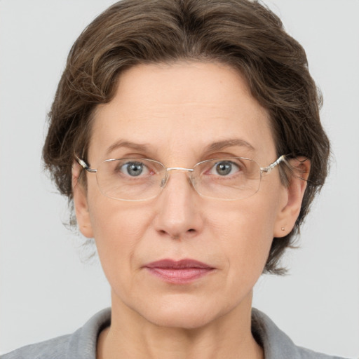 Joyful white adult female with short  brown hair and grey eyes