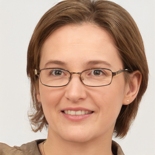 Joyful white adult female with medium  brown hair and grey eyes