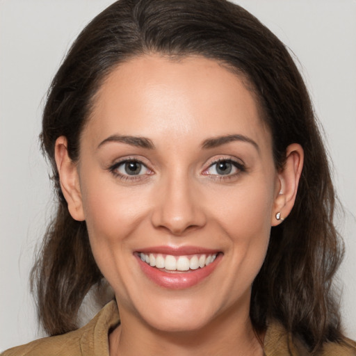 Joyful white young-adult female with medium  brown hair and brown eyes