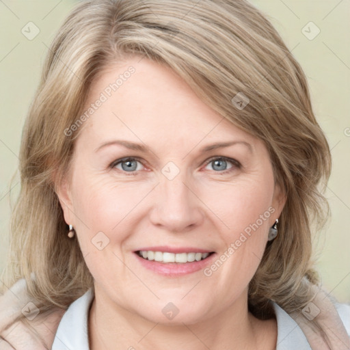 Joyful white adult female with medium  brown hair and blue eyes