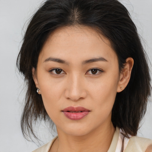 Joyful asian young-adult female with medium  brown hair and brown eyes