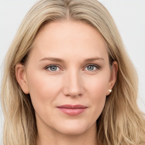 Joyful white young-adult female with long  brown hair and blue eyes