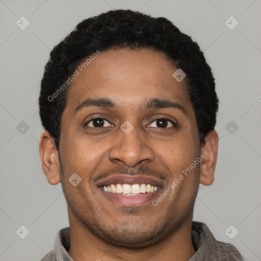 Joyful latino young-adult male with short  brown hair and brown eyes