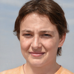 Joyful white adult female with medium  brown hair and brown eyes