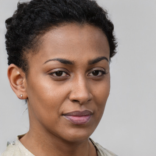 Joyful black young-adult female with short  brown hair and brown eyes