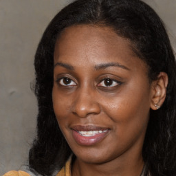 Joyful black young-adult female with medium  brown hair and brown eyes