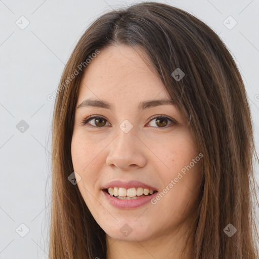 Joyful white young-adult female with long  brown hair and brown eyes