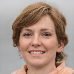 Joyful white young-adult female with medium  brown hair and blue eyes