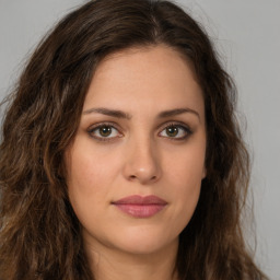 Joyful white young-adult female with long  brown hair and green eyes