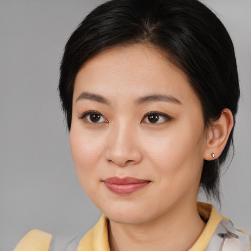 Joyful asian young-adult female with medium  brown hair and brown eyes