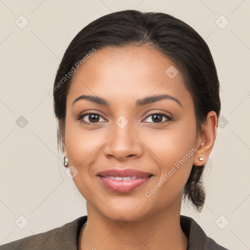 Joyful latino young-adult female with medium  brown hair and brown eyes