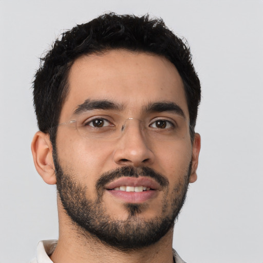 Joyful latino young-adult male with short  black hair and brown eyes