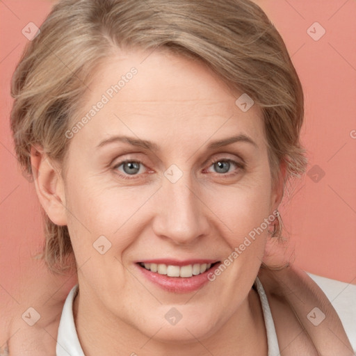 Joyful white adult female with medium  brown hair and blue eyes