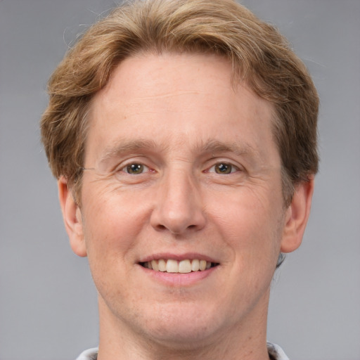 Joyful white adult male with short  brown hair and grey eyes