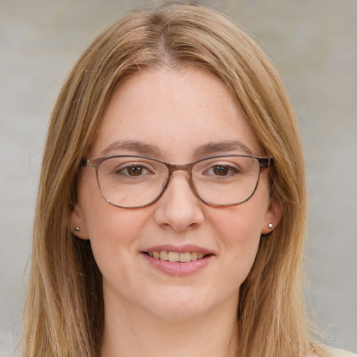 Joyful white young-adult female with long  brown hair and green eyes