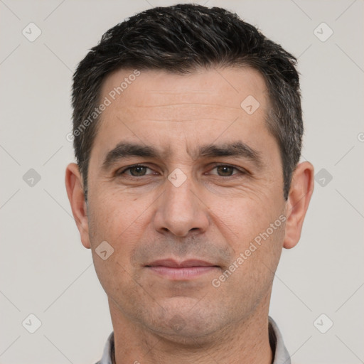 Joyful white adult male with short  black hair and brown eyes