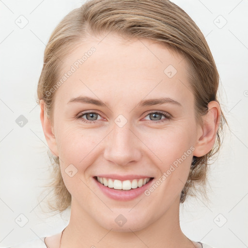 Joyful white young-adult female with medium  brown hair and blue eyes