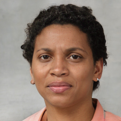 Joyful black adult female with short  brown hair and brown eyes