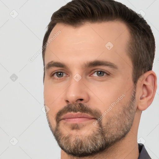 Joyful white young-adult male with short  brown hair and brown eyes