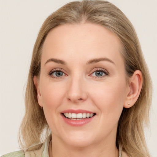 Joyful white young-adult female with medium  brown hair and blue eyes