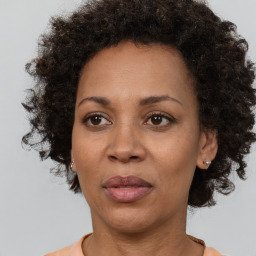 Joyful black adult female with short  brown hair and brown eyes