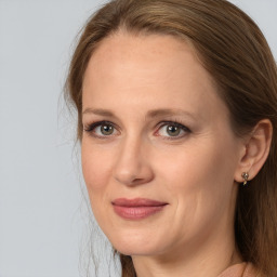 Joyful white adult female with long  brown hair and brown eyes