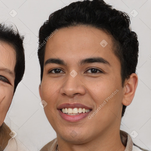 Joyful latino young-adult male with short  brown hair and brown eyes