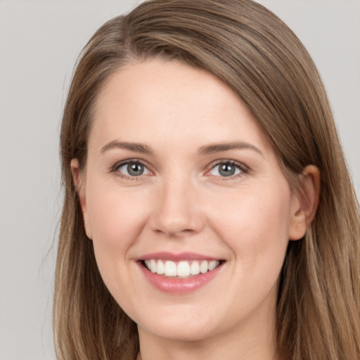 Joyful white young-adult female with long  brown hair and grey eyes