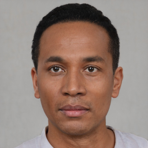 Neutral latino young-adult male with short  black hair and brown eyes