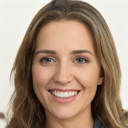 Joyful white young-adult female with long  brown hair and green eyes