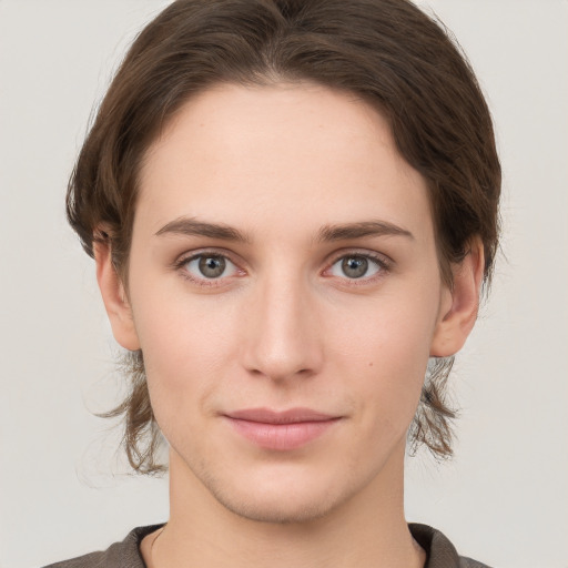 Joyful white young-adult female with short  brown hair and grey eyes