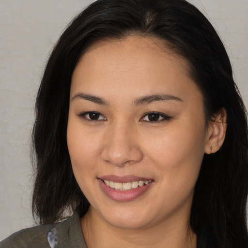 Joyful asian young-adult female with medium  brown hair and brown eyes