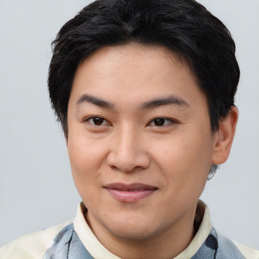 Joyful asian young-adult male with short  brown hair and brown eyes