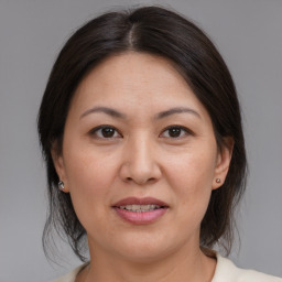 Joyful white adult female with medium  brown hair and brown eyes