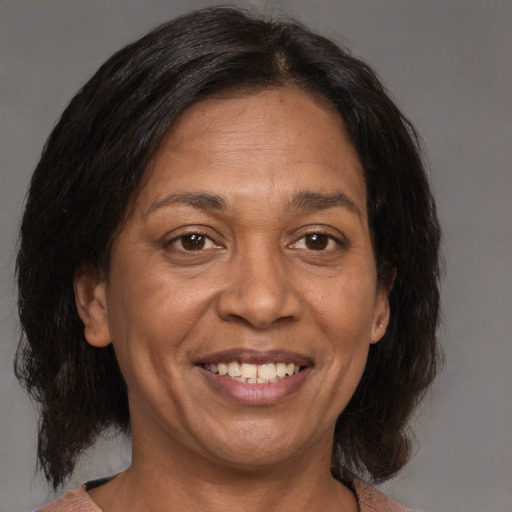 Joyful white adult female with medium  brown hair and brown eyes