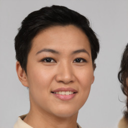 Joyful asian young-adult female with short  black hair and brown eyes