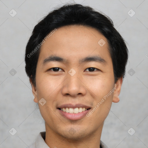 Joyful asian young-adult male with short  black hair and brown eyes