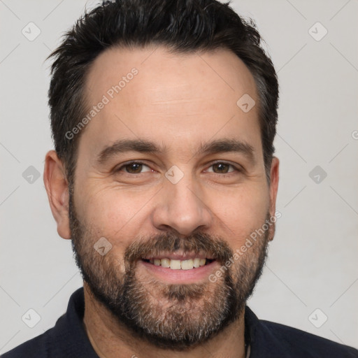 Joyful white adult male with short  black hair and brown eyes