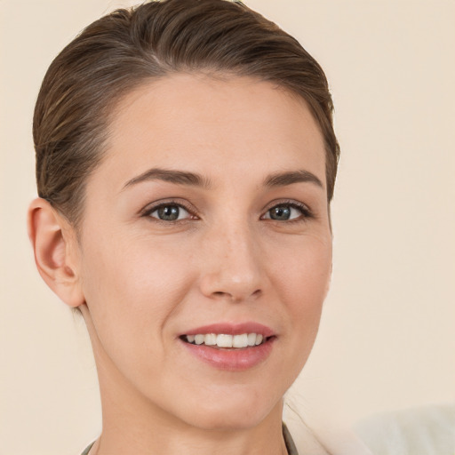 Joyful white young-adult female with short  brown hair and brown eyes