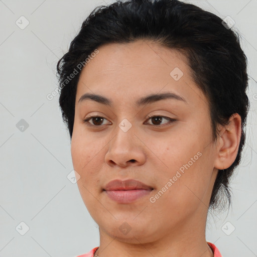 Joyful latino young-adult female with short  brown hair and brown eyes