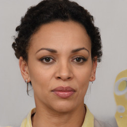 Joyful black adult female with short  brown hair and brown eyes