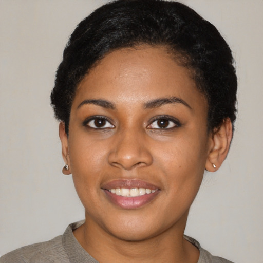 Joyful latino young-adult female with short  black hair and brown eyes