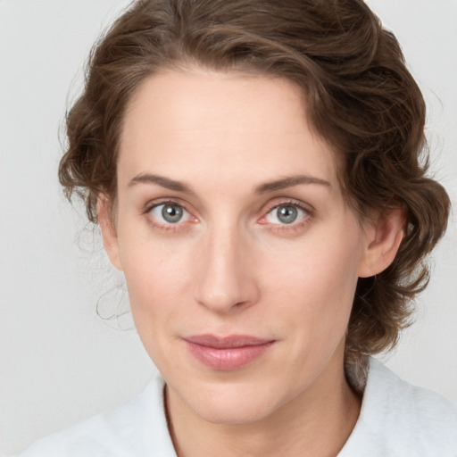 Joyful white young-adult female with medium  brown hair and green eyes