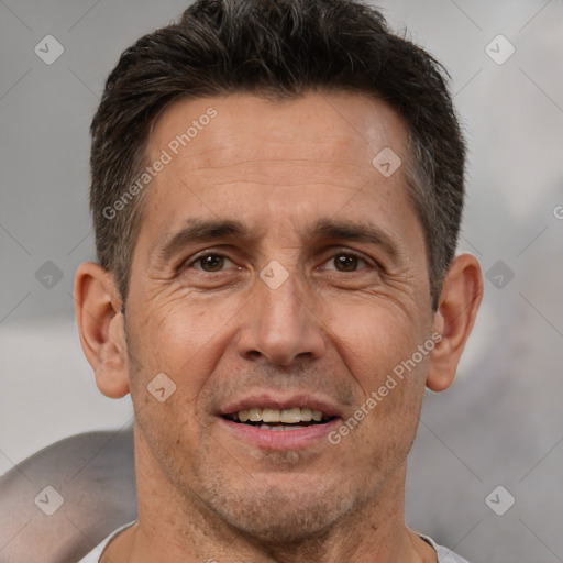 Joyful white adult male with short  brown hair and brown eyes