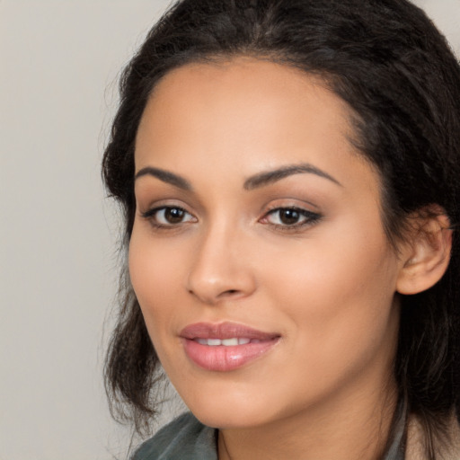 Joyful latino young-adult female with long  black hair and brown eyes