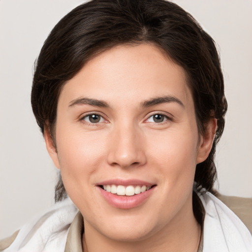 Joyful white young-adult female with medium  brown hair and brown eyes