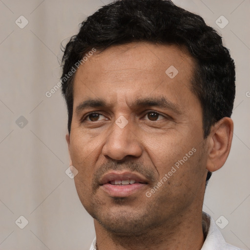 Joyful white adult male with short  black hair and brown eyes