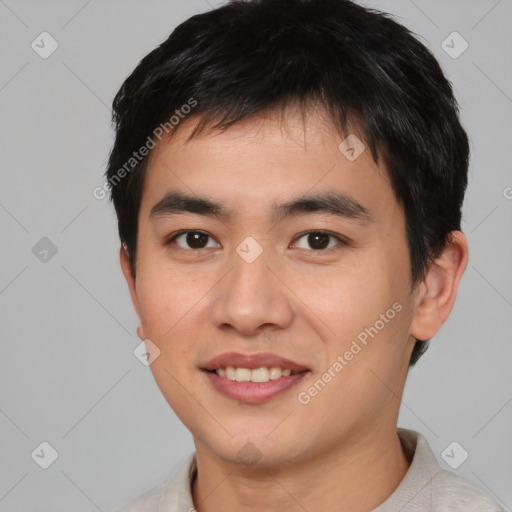 Joyful asian young-adult male with short  brown hair and brown eyes