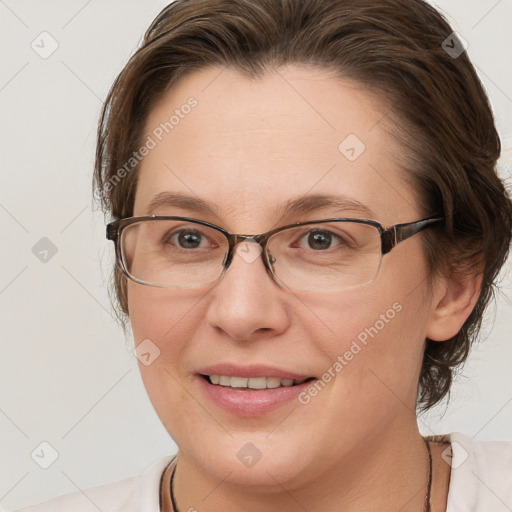 Joyful white adult female with medium  brown hair and blue eyes